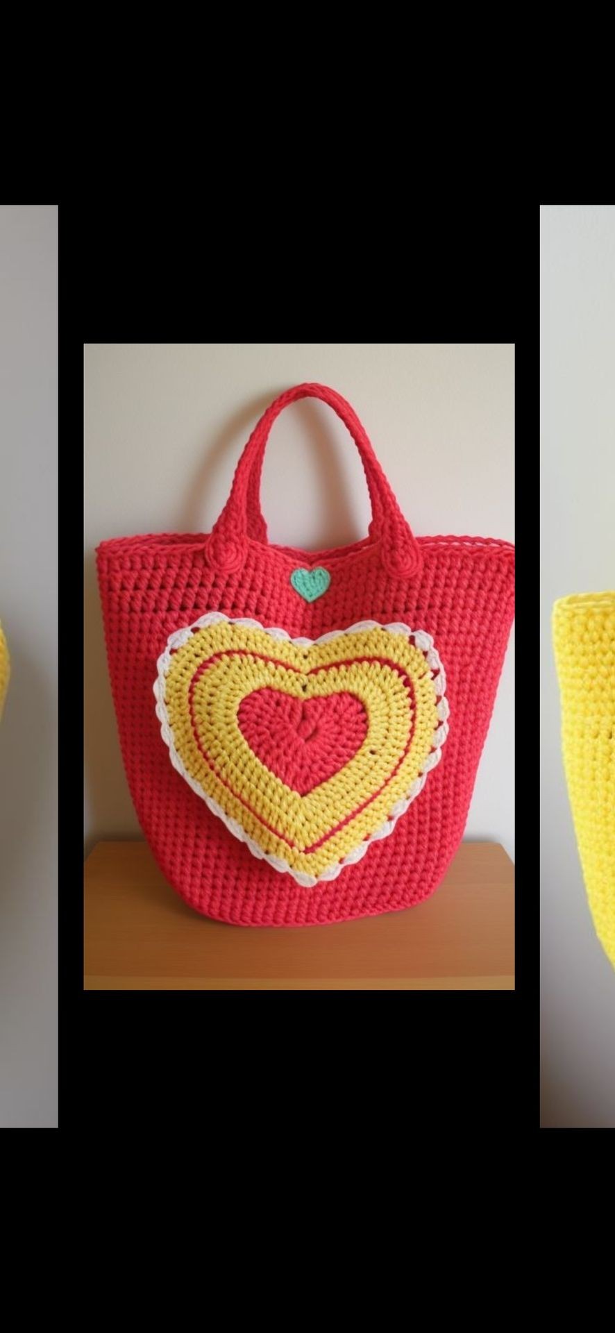 Handwoven red tote bag with yellow and red heart design on a wooden surface.